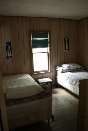 Pigeon Lake Resort Cottage Two.&nbsp; Bedroom with two single beds and a window in a cottage interior.